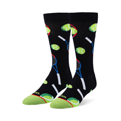 Black crew socks featuring a pattern of neon green tennis balls and blue and red rackets with a bright green toe cap.