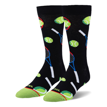 Black crew socks featuring a pattern of neon green tennis balls and blue and red rackets with a bright green toe cap.