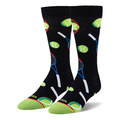 Black crew socks featuring a pattern of neon green tennis balls and blue and red rackets with a bright green toe cap.