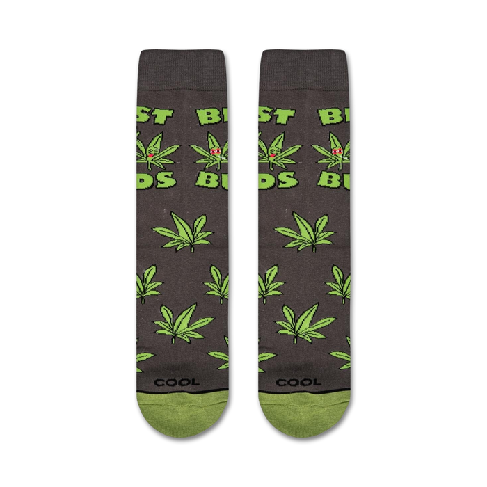 A gray sock with a green and red marijuana leaf pattern and the word 