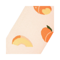Close-up angled view of a light peach sock fabric, showing a whole peach and a peach slice in detail.