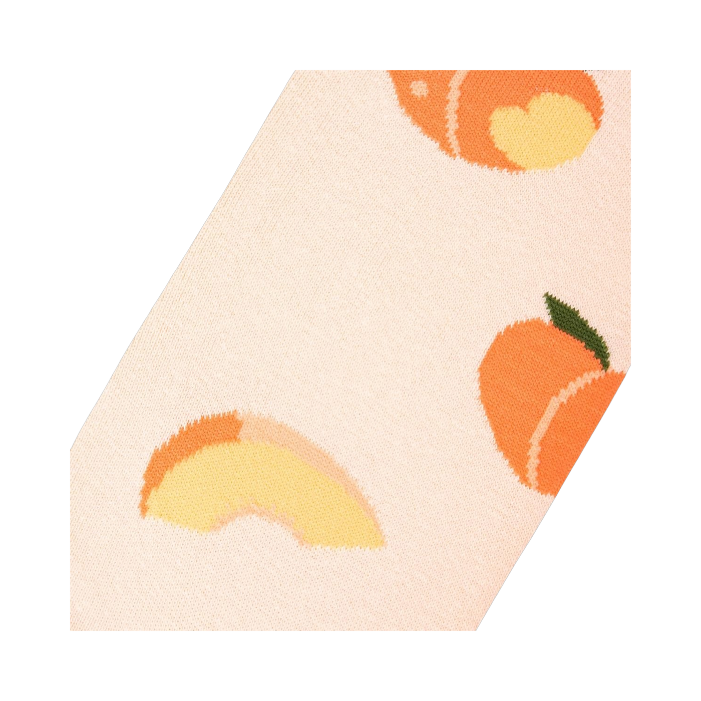 Close-up angled view of a light peach sock fabric, showing a whole peach and a peach slice in detail.