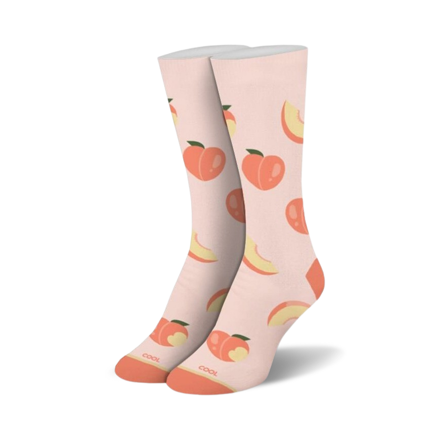 A pair of crew socks standing upright, light peach with an all-over pattern of whole peaches and peach slices, orange toes and heels.
