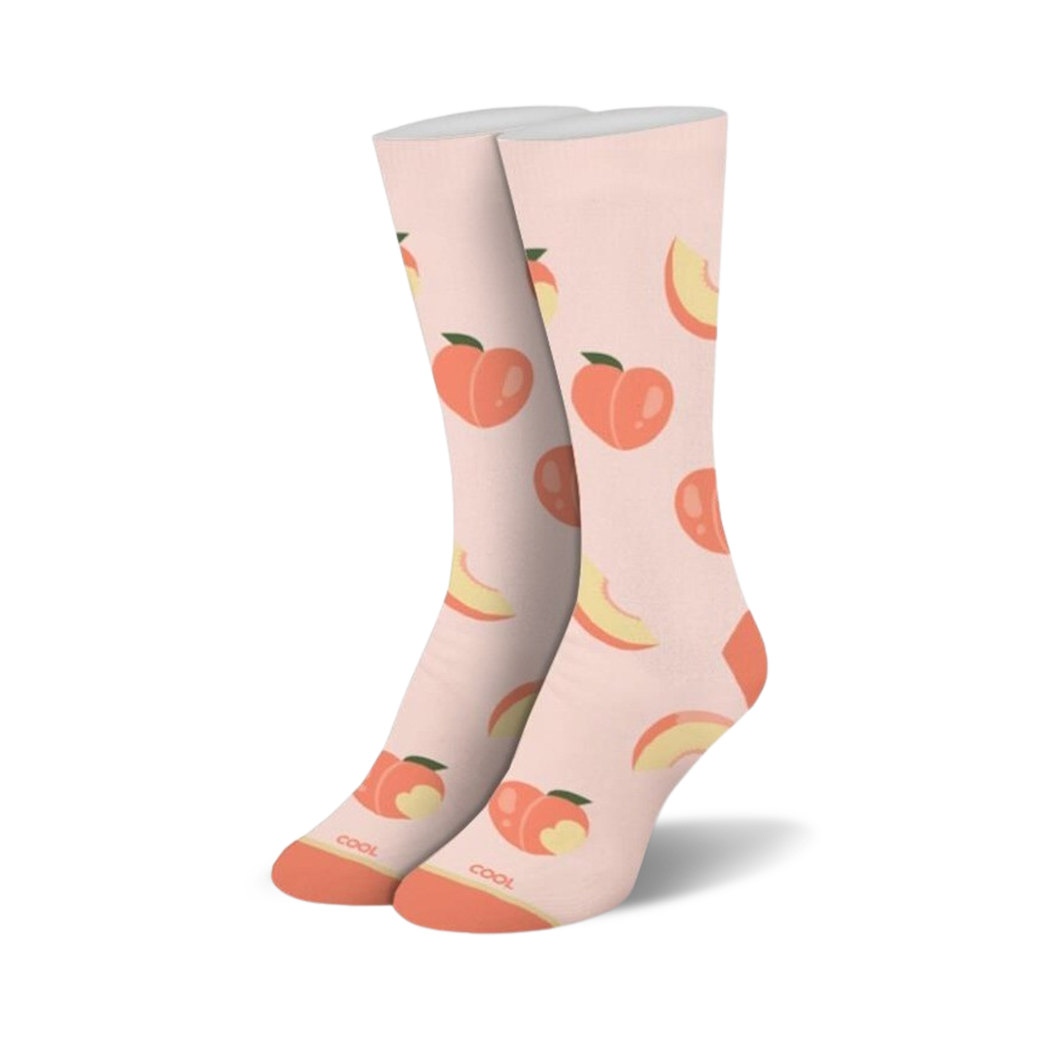 A pair of crew socks standing upright, light peach with an all-over pattern of whole peaches and peach slices, orange toes and heels.