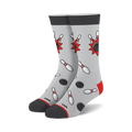 Pair of crew socks in gray, red, and white.  They feature a fun bowling-themed design with pins and balls.