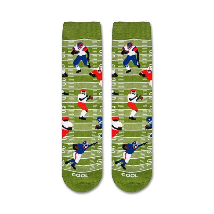 A pair of green socks with a football field pattern. The pattern includes two football players, one in blue and one in red.
