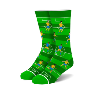 green crew socks with blue and yellow soccer players playing on a white field   