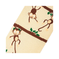 Close-up detail shot highlighting the whimsical monkey and branch design on the socks.