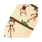 Close-up detail shot highlighting the whimsical monkey and branch design on the socks.