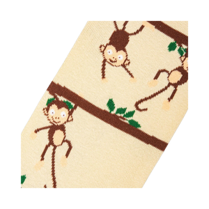 Close-up detail shot highlighting the whimsical monkey and branch design on the socks.