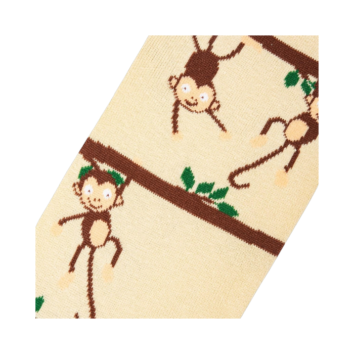 Close-up detail shot highlighting the whimsical monkey and branch design on the socks.