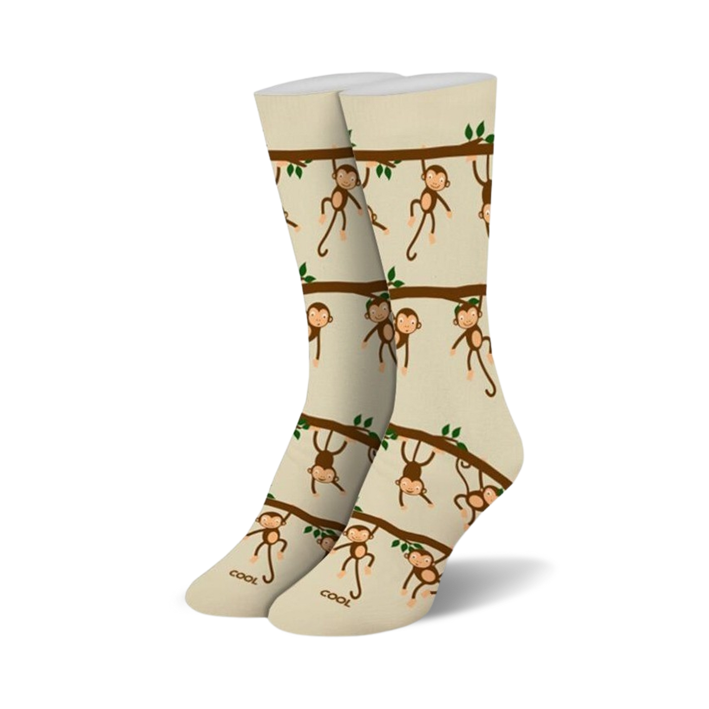 Pair of beige crew socks with a repeating pattern of brown monkeys hanging from tree branches. Green leaves are also included in the design.