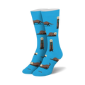 Pair of blue crew socks featuring a repeating pattern of brown sea otters holding kelp. 