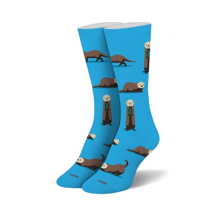 womens blue crew socks with brown and black cartoon sea otters. some of the sea otters hold fish.    