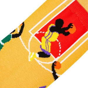 A yellow sock with a pattern of black and white basketballs and a cartoon basketball player in purple and yellow.