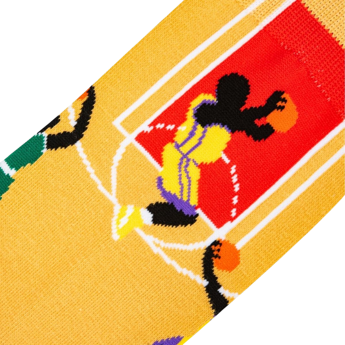 A yellow sock with a pattern of black and white basketballs and a cartoon basketball player in purple and yellow.
