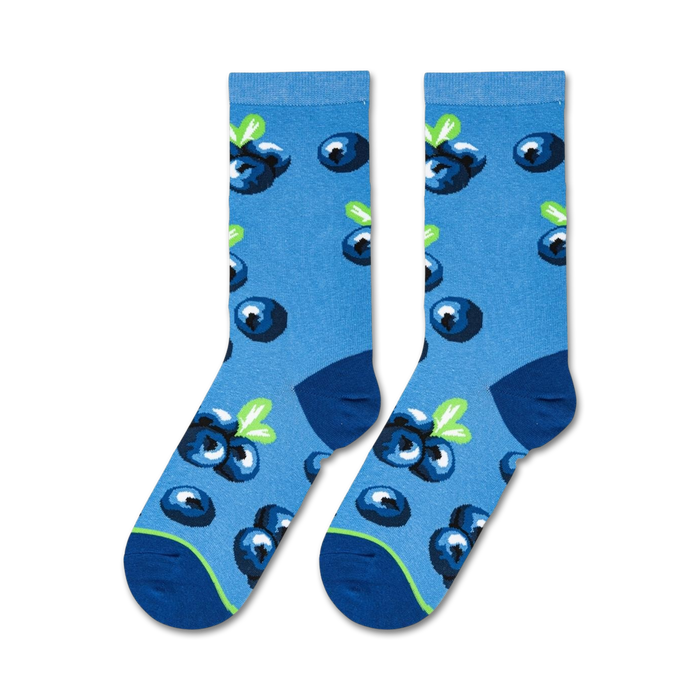 A close up of a pair of blue socks with a pattern of blueberries.