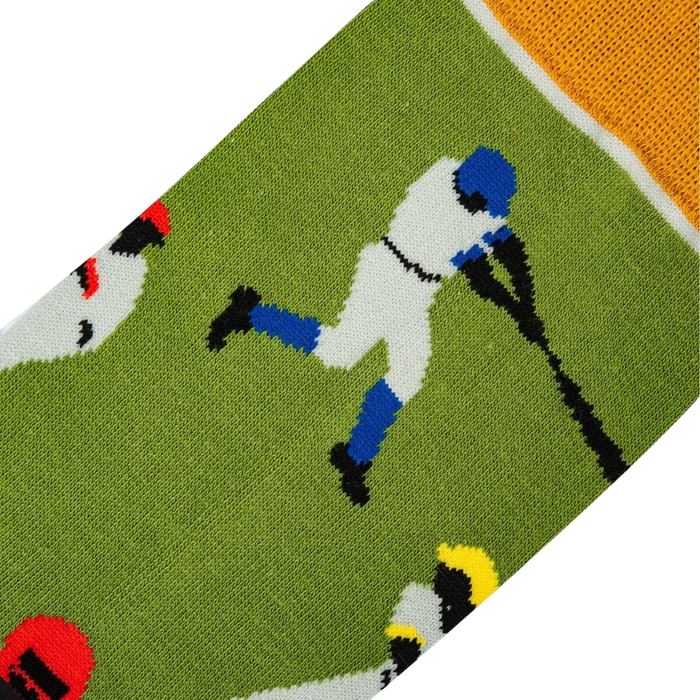 A green sock with a pattern of baseball players in blue, red, and white.