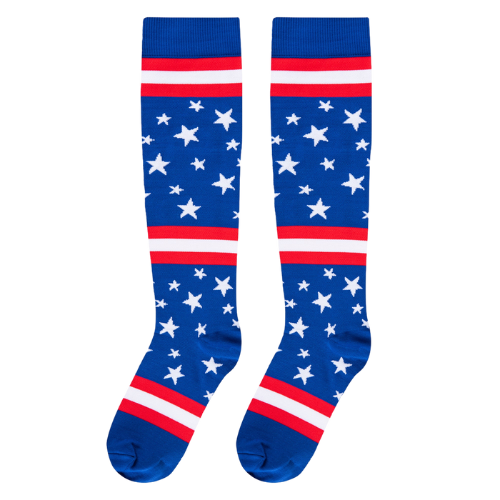 Flat front-facing view of two knee-high socks featuring a blue base, white stars, and red and white horizontal bands.
