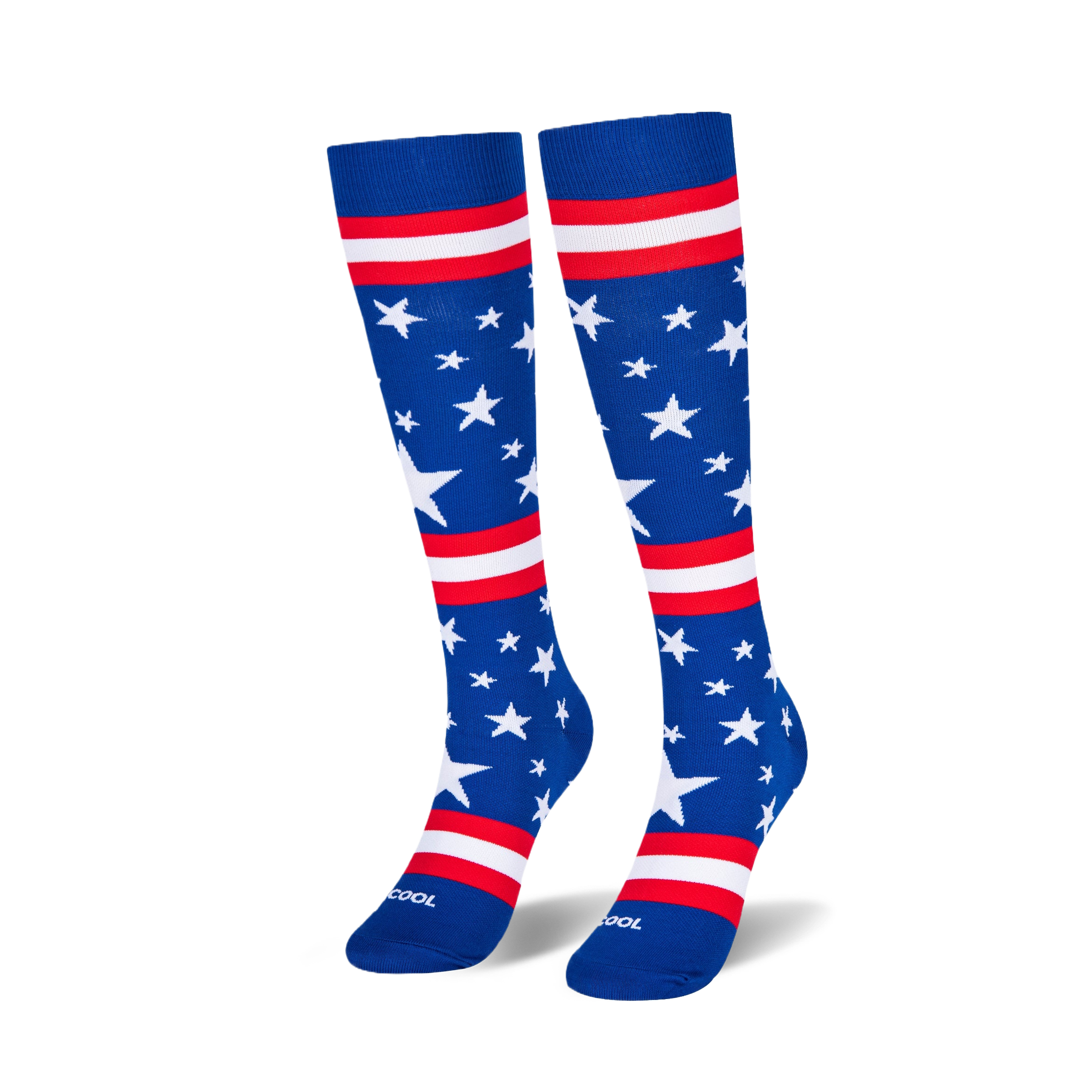 Two knee-high blue socks standing upright on a black surface, showing scattered white stars and red and white stripes.