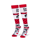 Angled studio shot of Betty Boop knee-high socks standing upright, highlighting the bold red polka dot stripes.