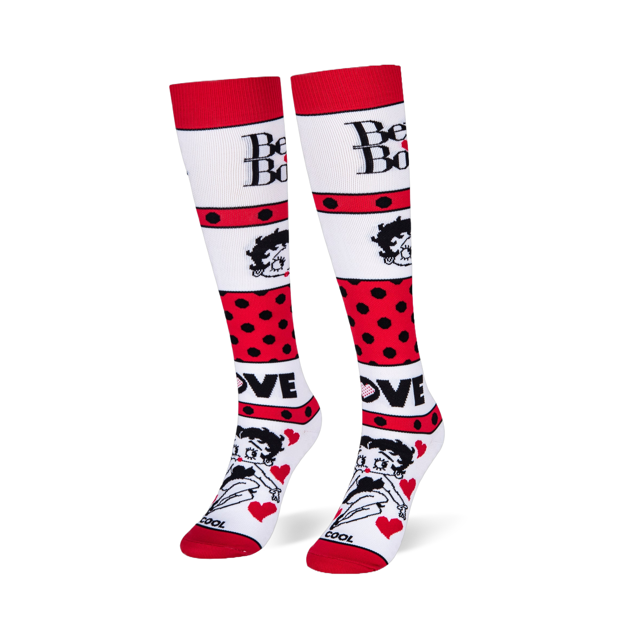 Angled studio shot of Betty Boop knee-high socks standing upright, highlighting the bold red polka dot stripes.