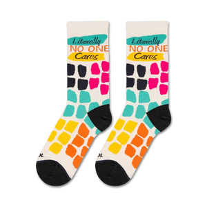 A close up of a pair of socks with a white background and colorful squares in a graph-like pattern. The squares are blue, green, pink, and black. The word 