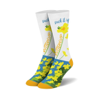 Pair of crew socks; white background with yellow flowers and 'Suck it up Buttercup' text; orange and blue accents at the cuffs.