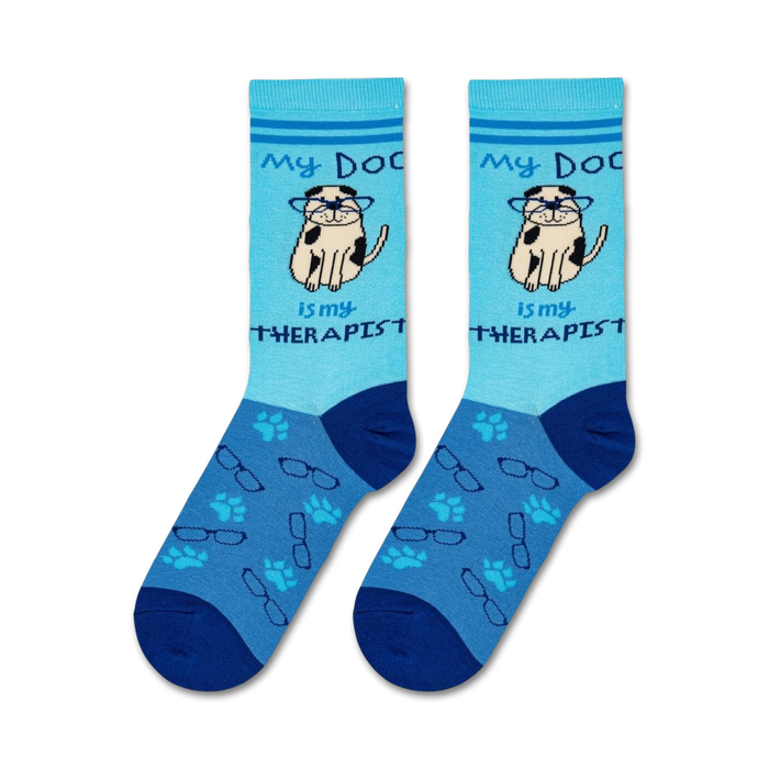 A blue sock with a cartoon dog wearing glasses on it. The dog is sitting and has a paw raised. The words 