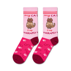 Flatlay product shot of two 'Cat Therapist' socks on a white background.