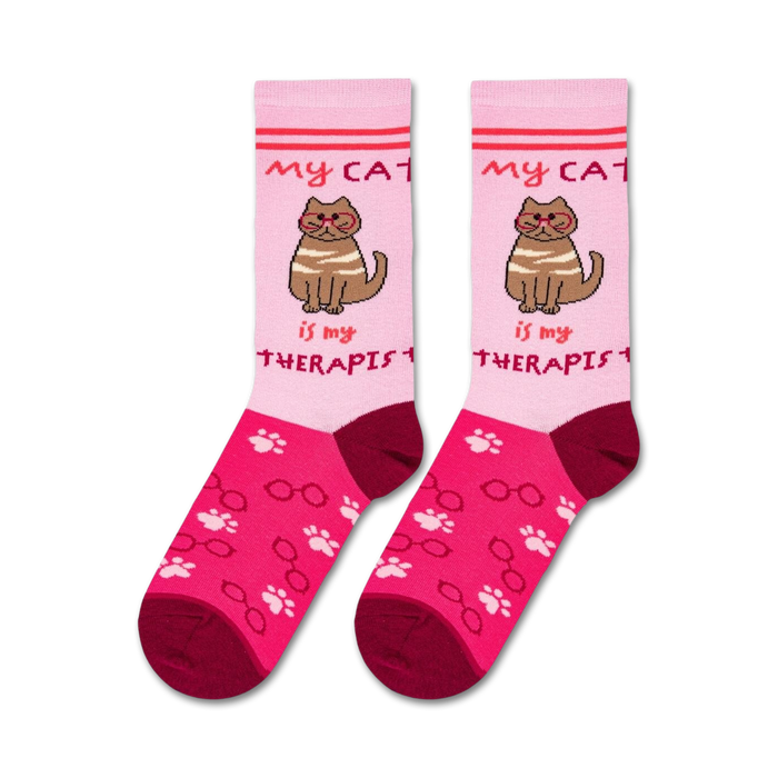A pink sock with the image of a brown cat wearing glasses and the words 