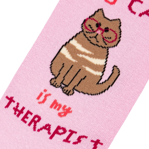 A pink sock with the image of a brown cat wearing glasses and the words 
