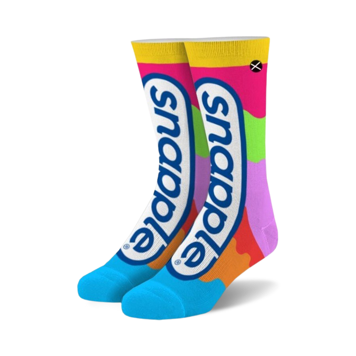 colorful snapple themed crew socks for men and women featuring a repeating snapple pattern on a pink, green, orange, purple, and yellow background. toe and heel are blue.   }}