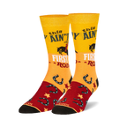 Pair of crew socks in yellow, red, and black.  Features a cowgirl riding a horse, horseshoes, and the text 'This ain't my first rodeo'.