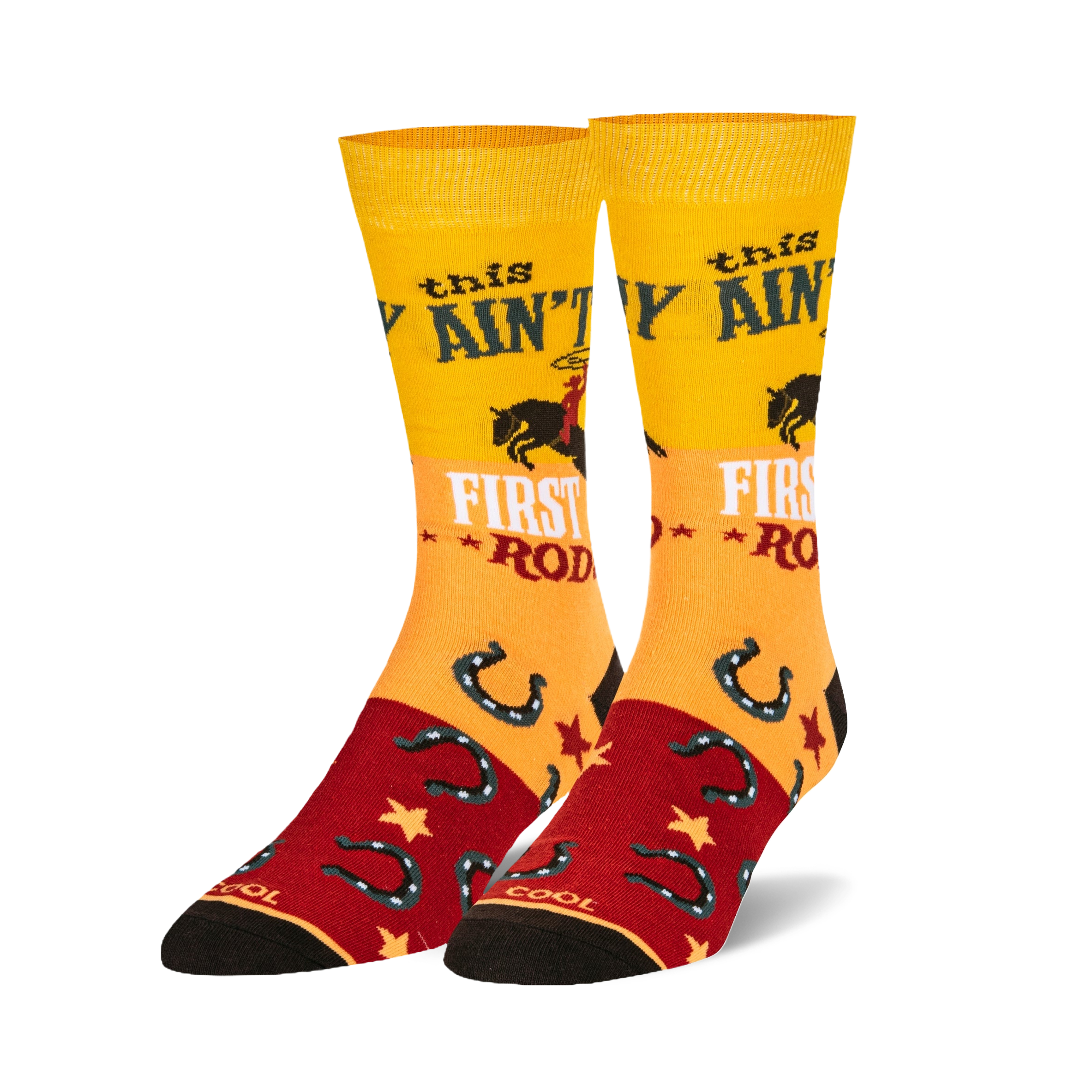 Pair of crew socks in yellow, red, and black.  Features a cowgirl riding a horse, horseshoes, and the text 'This ain't my first rodeo'.