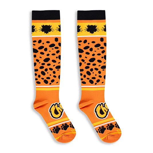 Flat lay of knee-high orange Cheetos socks showing the black cheetah pattern, yellow stripe, and paw prints on the toes.