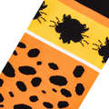 Close-up fabric detail of orange socks showing knitted black cheetah spots and a Chester Cheetah face silhouette on yellow.