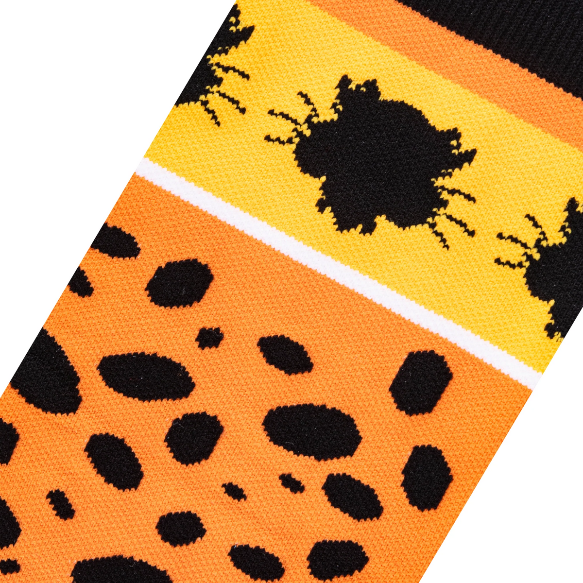 Close-up fabric detail of orange socks showing knitted black cheetah spots and a Chester Cheetah face silhouette on yellow.