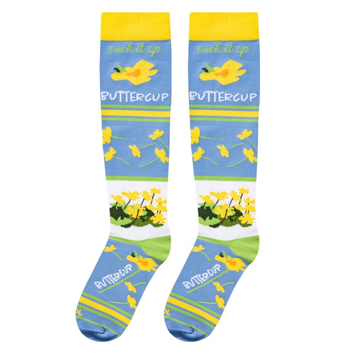 Full flat lay of blue floral socks highlighting the yellow cuffs and buttercup pattern with the word COOL on the toe.