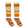 Knee-high Reese's Pieces socks laid flat against a black background, displaying the bold logo text across the foot and calf.