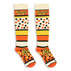 Knee-high Reese's Pieces socks laid flat against a black background, displaying the bold logo text across the foot and calf.