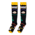 Flat lay of black knee-high socks highlighting Tommy Pickles, Reptar on the side, and the Rugrats logo near a yellow cuff.