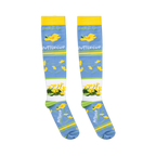 Flat lay of light blue socks showing the cursive suck it up text above scattered yellow buttercups.