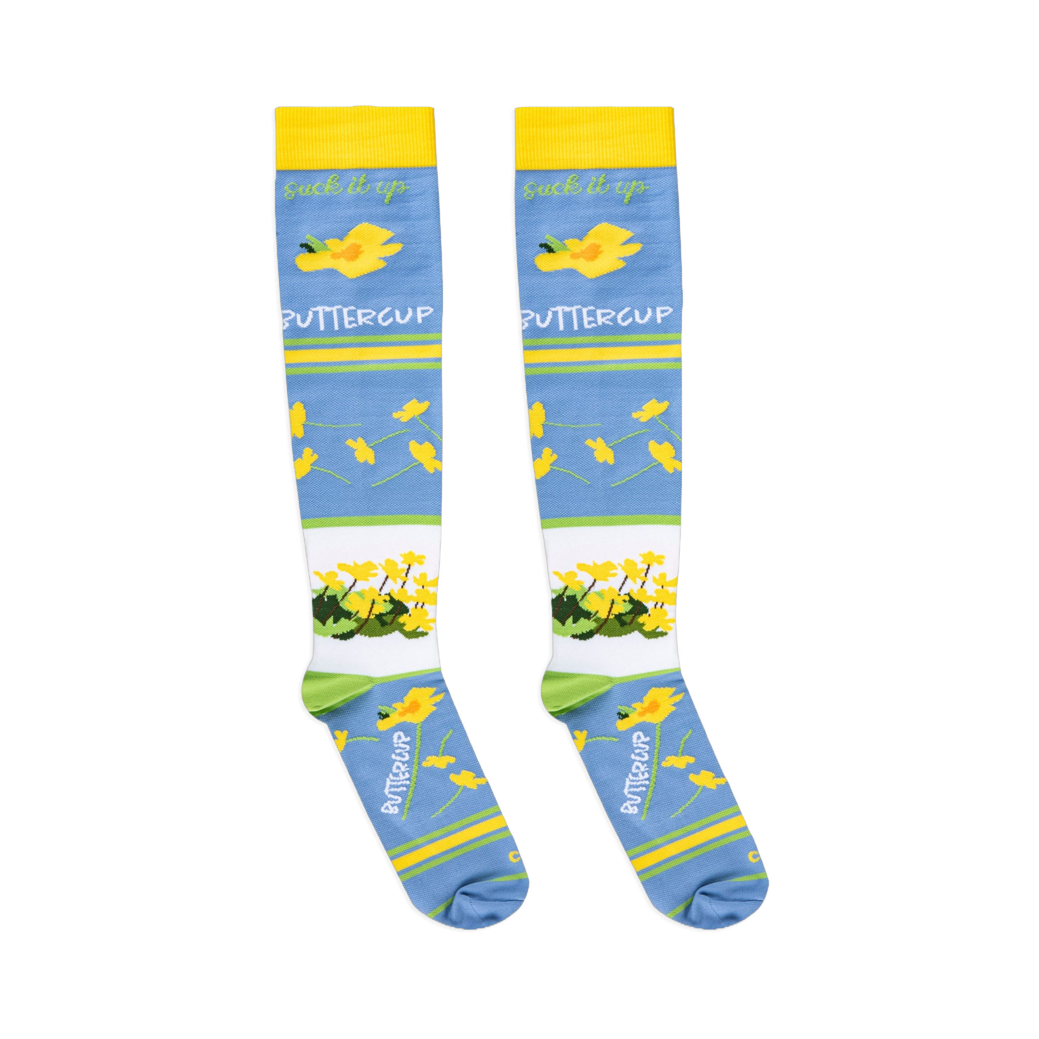 Flat lay of light blue socks showing the cursive suck it up text above scattered yellow buttercups.