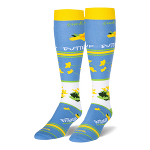 Light blue knee-high socks featuring yellow cuffs and buttercup patterns alongside text reading suck it up BUTTERCUP.