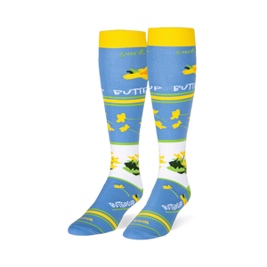 Light blue knee-high socks featuring yellow cuffs and buttercup patterns alongside text reading suck it up BUTTERCUP.