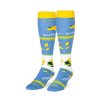 Light blue knee-high socks featuring yellow cuffs and buttercup patterns alongside text reading suck it up BUTTERCUP.