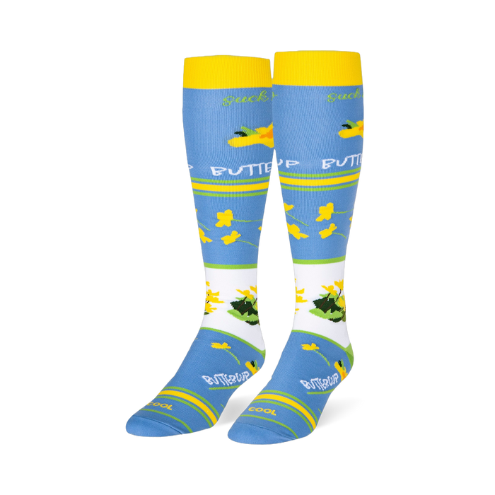 Light blue knee-high socks featuring yellow cuffs and buttercup patterns alongside text reading suck it up BUTTERCUP.