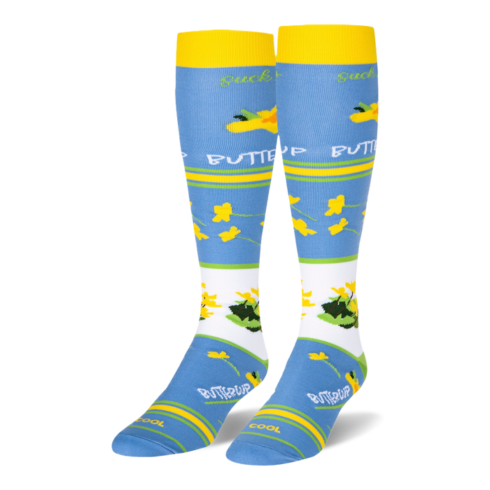 Light blue knee-high socks featuring yellow cuffs and buttercup patterns alongside text reading suck it up BUTTERCUP.