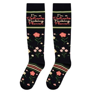 Close-up showcasing the sock's floral pattern and 'I'm a Delicate Fucking Flower' text.
